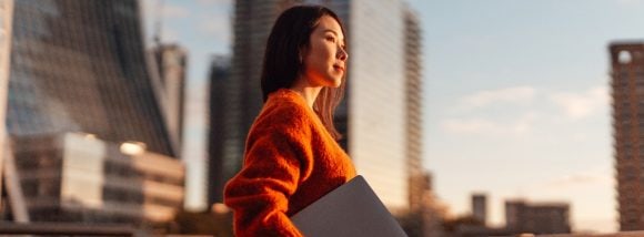 Businesswoman with laptop against London financial district