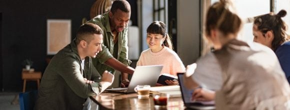 Diverse team having meeting in open workspace