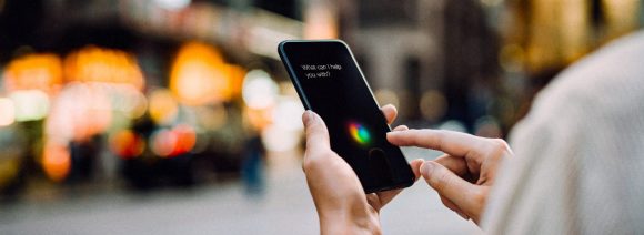 Businesswoman using AI assistant on smartphone