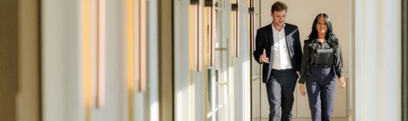 Employees having conversation in corridor at UBS Paris