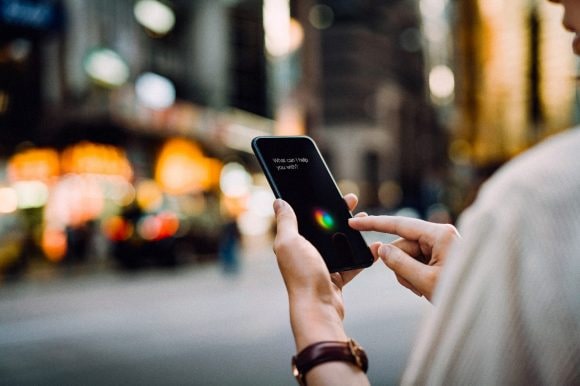 Businesswoman using AI assistant on smartphone
