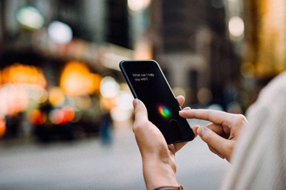 Businesswoman using AI assistant on smartphone