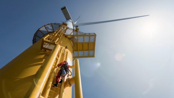 Engineer climbing wind turbine