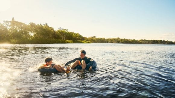 Father and son enjoying in the river