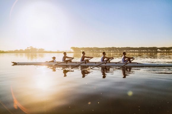 Rowing team training on lake