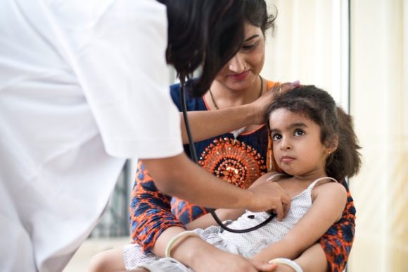 A doctor caring for a child for optimus health