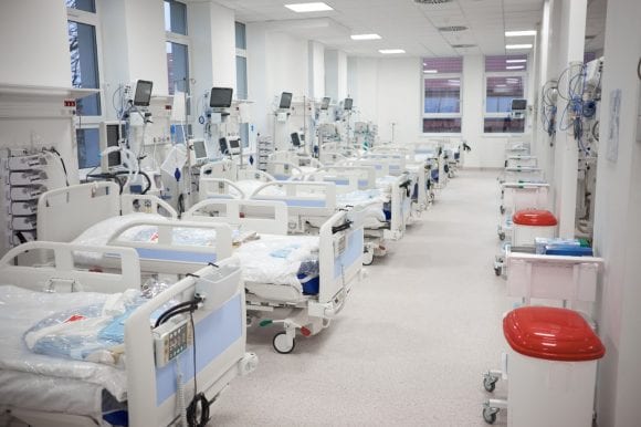 Beds in a hospital ward to represent primary healthcare and optimus health