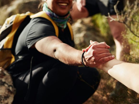 Two women reaching out hands