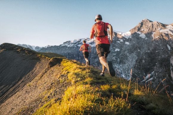 2 runners running at mountain top