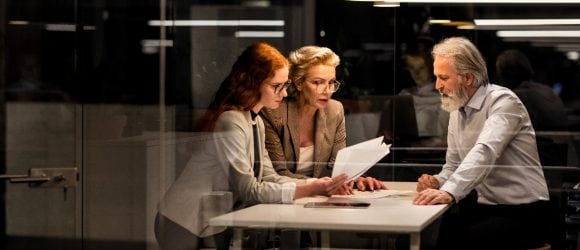 Business people discussing in office at night