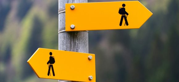 A yellow sign with black images on it