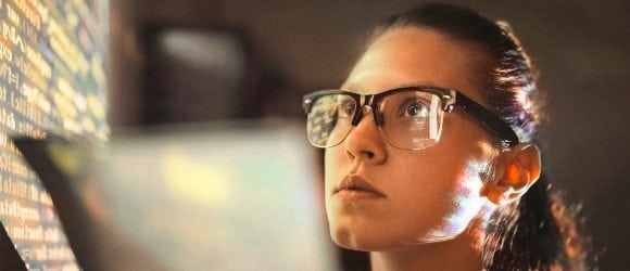 Woman looking at wall with computer code