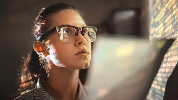 Woman looking at wall with computer code