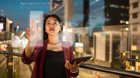 Businesswomen with tablet computer looking out of window