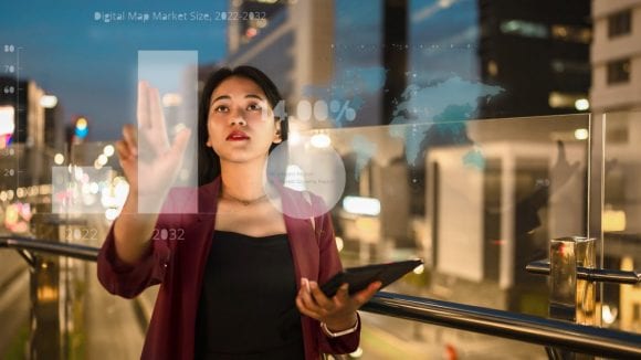  Businesswomen with tablet computer looking out of window