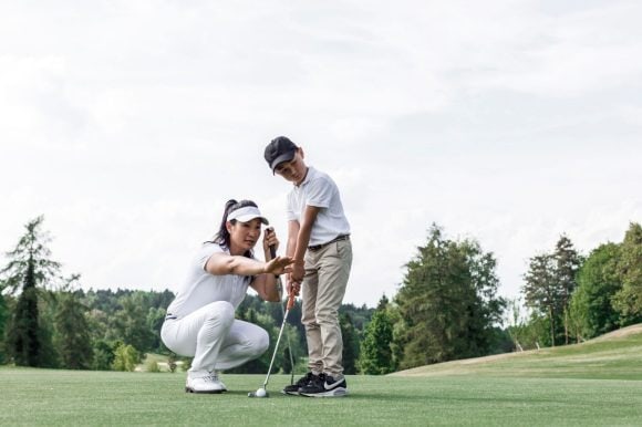Mother and son playing golf