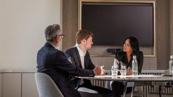  Three people having meeting in conference room at UBS Paris