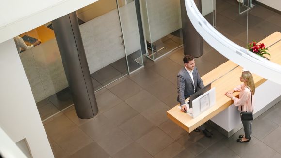 Close-up of tablet newspaper and eyeglasses.