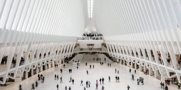 Houseview - Travel lifestyle at the WTC Transportation Hub in New York City. Commuters in a large hall.
