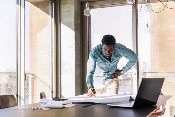 Man with plan in office