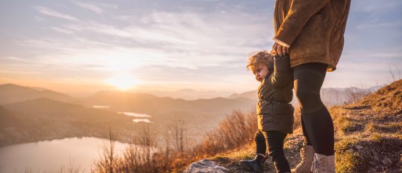 Mother with child on mountain top overlooking Lake Lugano