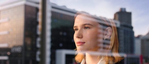 Businesswoman looking through window