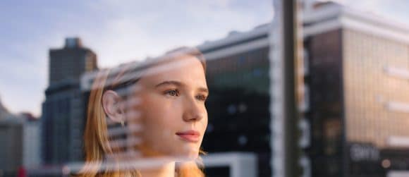 Businesswoman looking through window