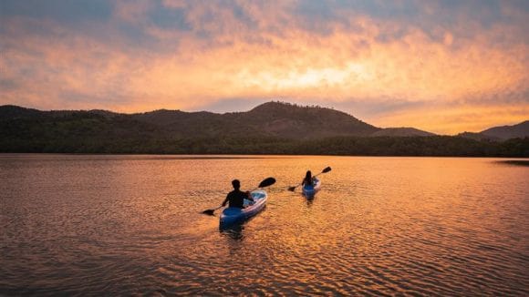 Senior parents and younger couple socializing in the living room