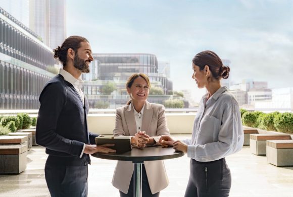 three colleagues talking with each other