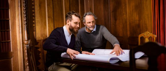 Two men discussing architectural plan