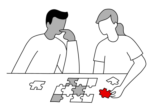 Image of two persons collecting puzzle