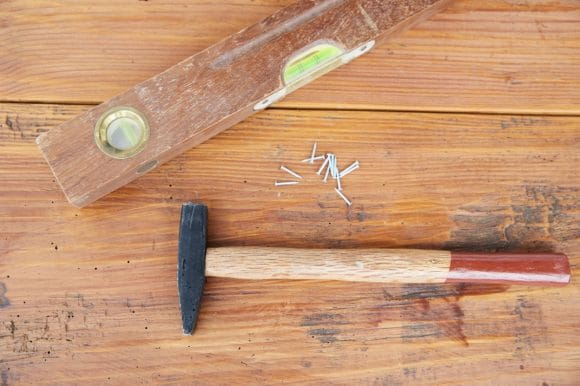 Spirit level and hammer