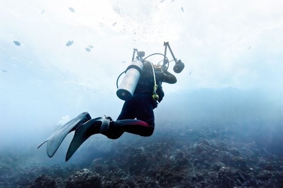 Scuba diver diving around the Cocos Islands