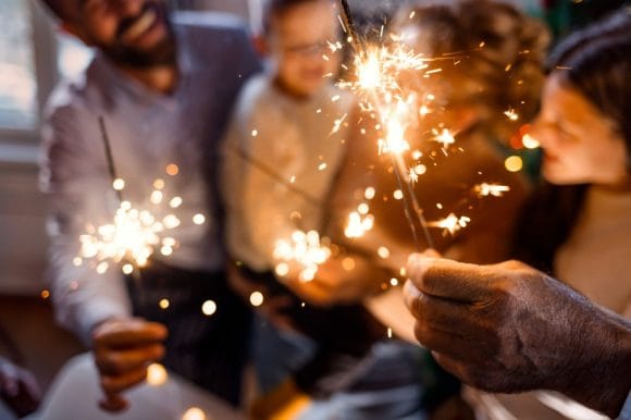  Family celebrating New Year with sparklers