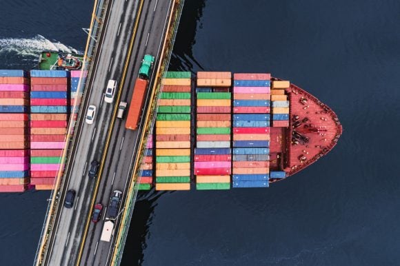 Container ship passing under the bridge