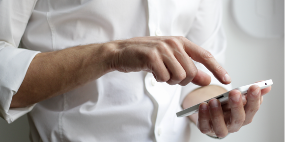 man confirming something on iphone