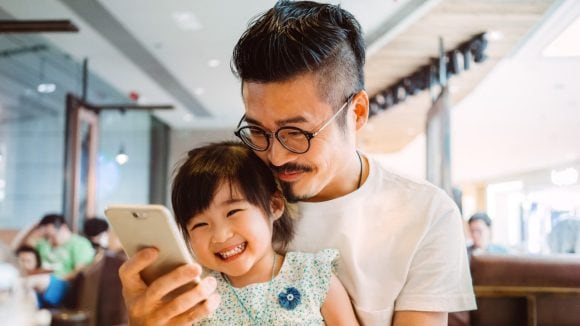 Father and daughter with phone