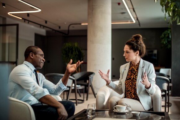 Two people in discussion at a workplace