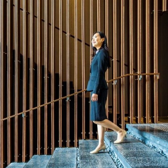 Asian woman walking down the stairs