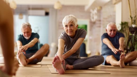 Men and women practicing yoga.