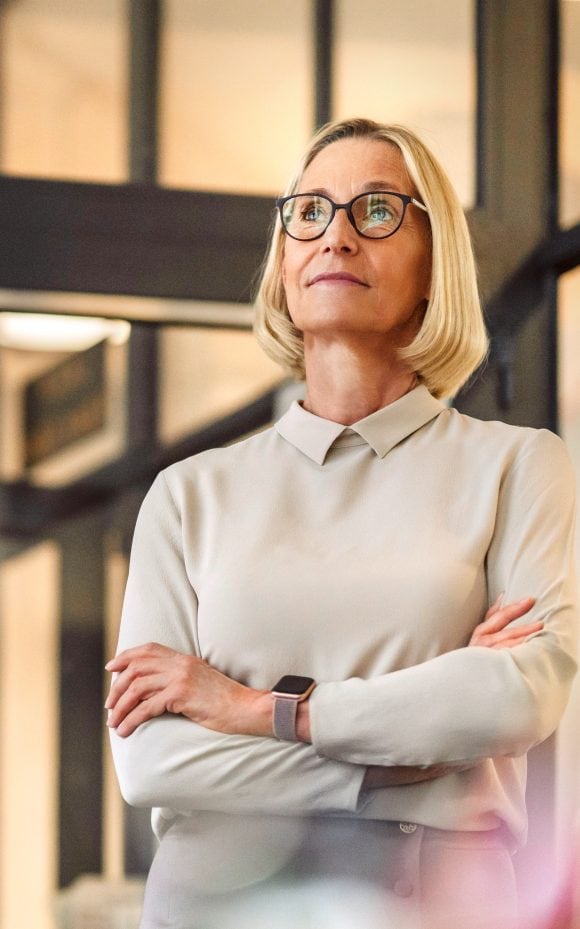 Woman with glasses looking confidently into the distance