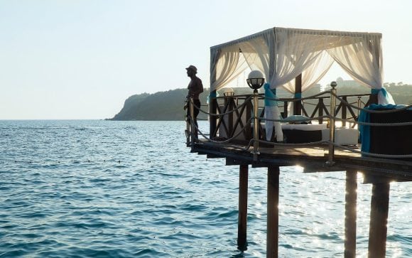 man on platform over sea