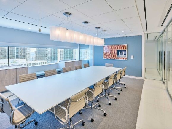 meeting room with a table, pendent light and chairs