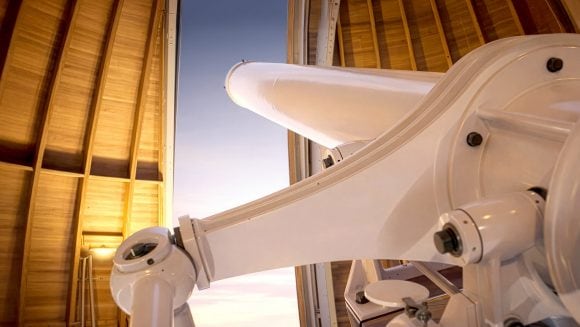 Closeup of a high-powered telescope looking into the sky