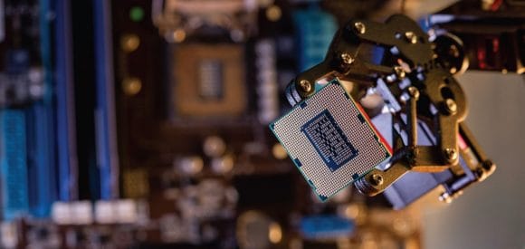 Robotic arm holding computer chip