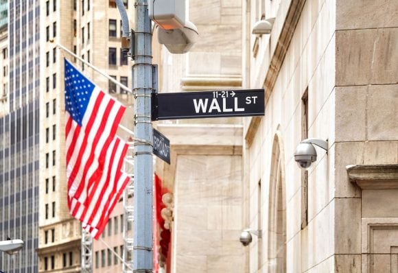 Wall street with US flag in the background