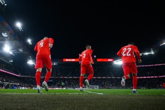 Three football players on the pitch