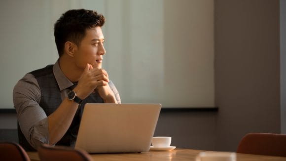 Man thinking on his laptop