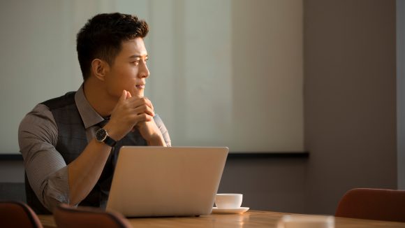 Man thinking on his laptop