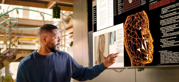 Man working with AI on computer